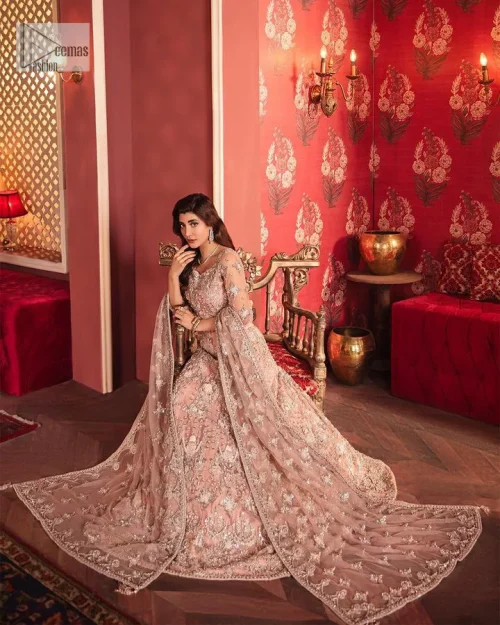 The beautiful outfit comes has an alluring peach colour and is gracefully emblazoned with embroidery. Hand-crafted details of tilla, dabka,