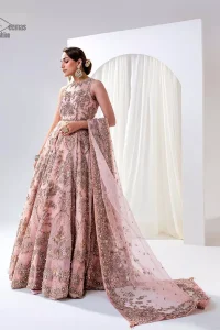 Matching embellishments are here to stay. The attractive tea pink nikah article is a stunning attire adorned with tilla, dabka, kora, Kundan, Zardozi and Gota.  Hand-crafted embellishments of golden and silver embroidery and floral patterns give a perfect finishing look to the maxi. The following scalloped maxi has a jewel neckline to make this unique and charming. In addition to this, the sleeveless style of the maxi is a breathtaking masterpiece that will give the gorgeous bride a breathtaking traditional look at the wedding. It is paired up with a plain lehenga to balance the astonishing look. Finish this with a dupatta that has four-sided embellished borders and tiny floral motifs all over to make your day glow and flowery.