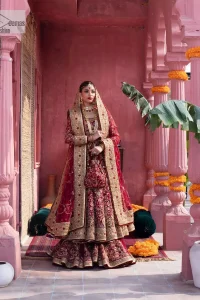 Deep shades of this reception wear just to brighten up your days. The deep red frock is intricately emblazoned with golden embellishments. Red floral designs and threads give an elegant touch to the frock Graceful details of tilla, dabka, kora, Kundan and Zardozi make this beautiful frock a perfect choice to pair with Wedding sharara. The round neckline of the following blouse intensifies the beauty. Furthermore, the full sleeves are decorated with floral patterns. The following deep red frock is coordinated with fish cut sharara having detailed embroidery. Complete this outfit with a dupatta framed with four-sided borders and floral jaal all over.
