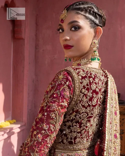 Deep shades of this reception wear just to brighten up your days. The deep red frock is intricately emblazoned with