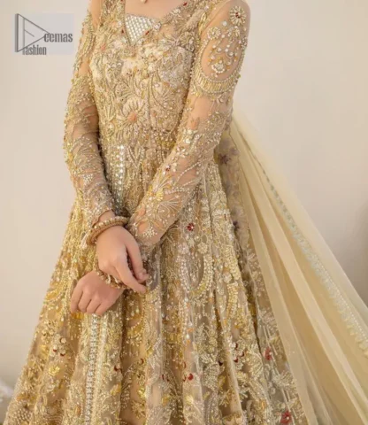 Make a statement wherever you go with a great selection of fawn colours just for you! A beautiful fawn scalloped maxi with a medley of hand-embellished floral motifs and geometric patterns in silver and gold colour. The maxi is enhanced with tilla, dabka, kora, Kundan and the real magic of Zardozi. The V shape neckline makes this walima outfit charming and attractive. Further, the patterns on full sleeves also intensify its loveliness. It is paired with an embellished floral border lehenga served with a scalloped. A net dupatta with sequin spray and intricate borders completes a gorgeous outfit.