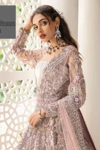 Deemas Fashion tea pink dress is an assortment of celebrations and rituals where luxury plays a significant role. This fully embellished traditional dress makes minimal use of jewelry as its sleeves, back train and huge flare is perfectly enriched with embroidery, so no element of the dress or bride herself is without decoration. 