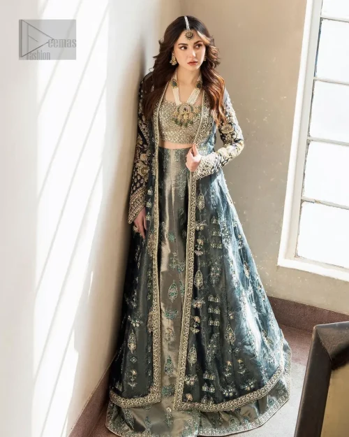 This unique teal front open dress is a masterpiece of design, that is decorated with tilla, dabka, kora and Kundan