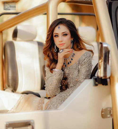 The embellished bodice with delicate silver embroidery adds a subtle touch of sparkle. The flowing maxi cascades down, complete with