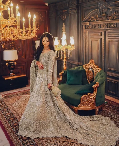 The scalloped edges of the dupatta add an enchanting detail, trailing behind you like a whisper of elegance. Adorned with