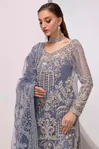 The shirt, with its full sleeves and V-neckline, is adorned with delicate silver & golden embroidery, creating a harmonious blend of tradition and luxury.