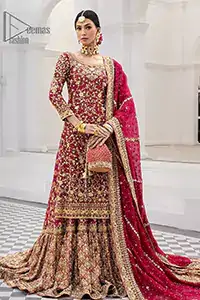 The exquisite lehenga is crafted with luxurious jamawar, offering a stunning deep red shade that radiates pure elegance. Adding more to its royalty, the shirt is adorned with intricate golden embroidery, while the dramatic back train and Farshi style bring regal charm to every step.