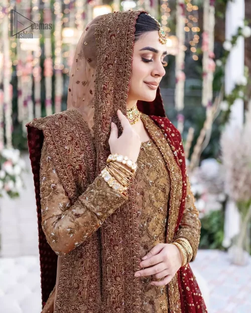 The copper long shirt is paired with a farshi-style lehenga and a maroon Organza dupatta to create a traditional look.