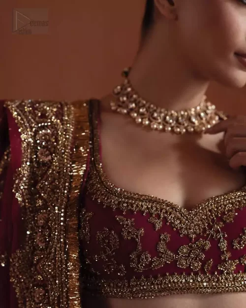 Neckline Artistry: Close-up of the beautiful sweetheart neckline on the fuchsia blouse, featuring precise golden and sculptured embroidery.