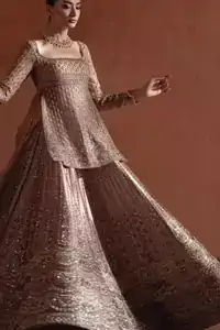Golden Short Shirt Flared Lehenga Sheer Dupatta. Sprinkled Motifs Detail: Detailed shot of the tiny floral motifs and sequins sprinkled across the flared golden lehenga.