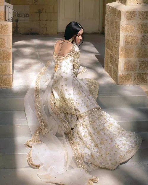 Wide-flare katan organza gharara lower hemline with heavy golden embroidery.