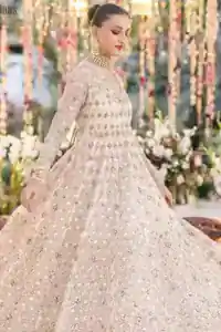 Dynamic three-quarter view of ivory wide-flare pishwas in motion.