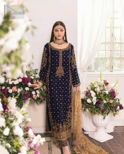 The midnight blue raw silk shirt with golden embroidery, paired with culottes, creates a structured yet fluid silhouette for evening