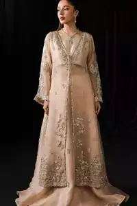 Its full sleeves and a square neckline frame elegance to create a balance between structure and fluidity. The lehenga sways beneath in organza layers, and whispers serenity with every step.